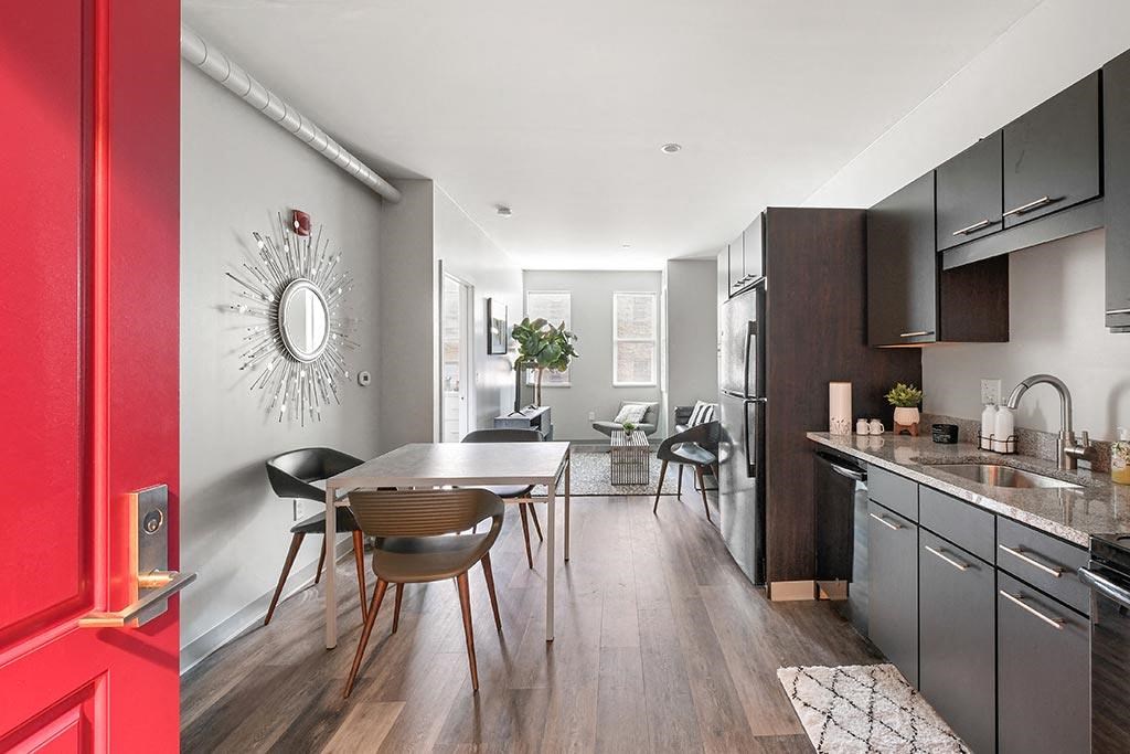 a kitchen and dining room with a table and chairs