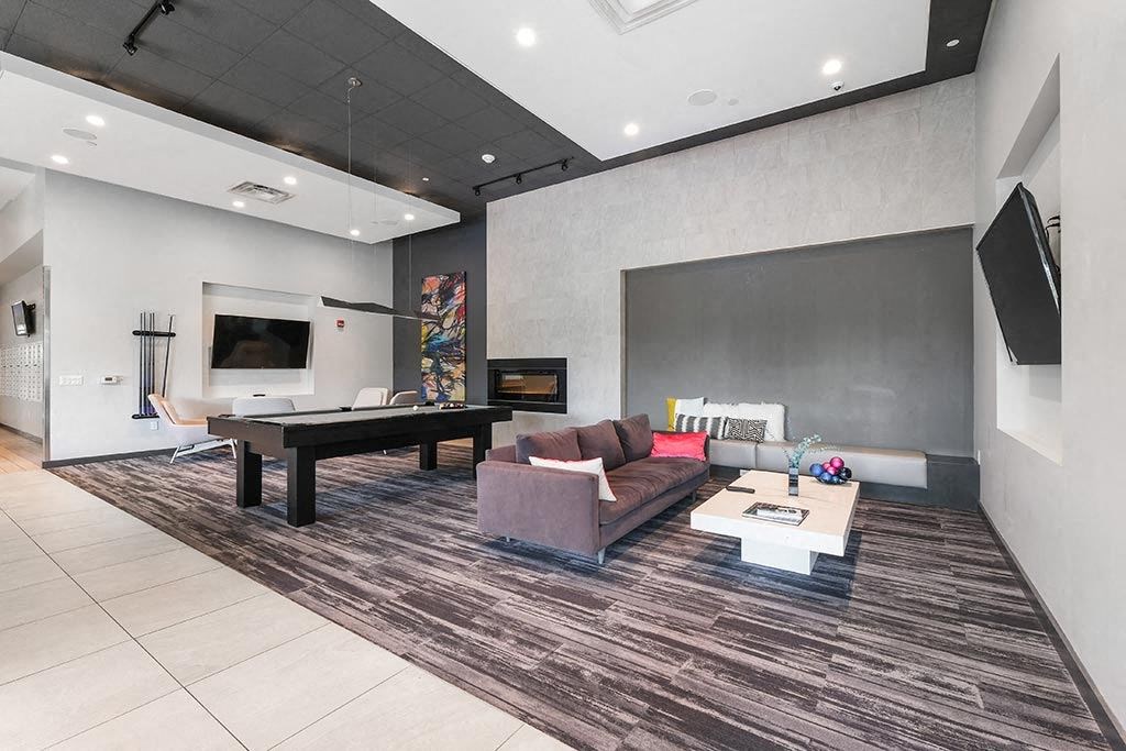 a living room with a pool table and a television