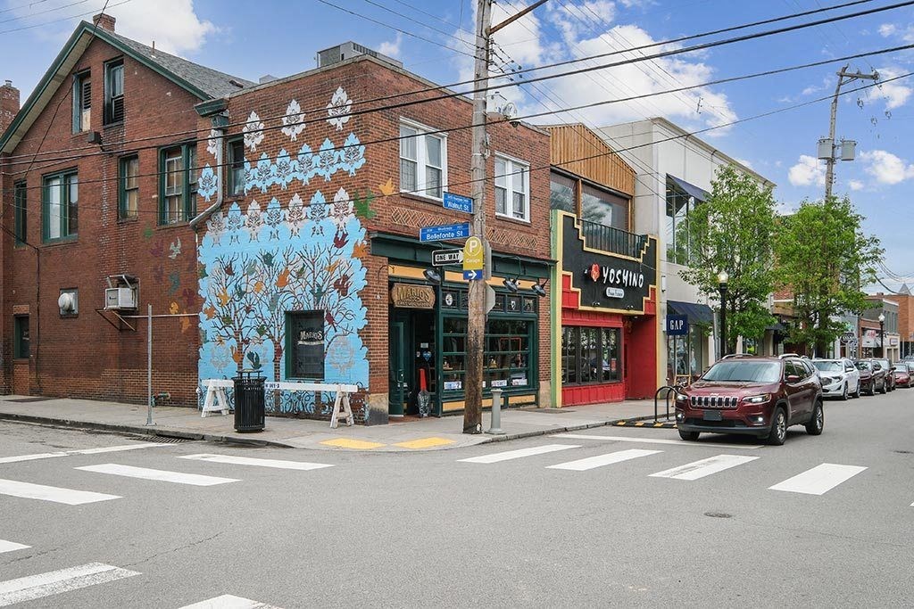 a mural on the side of a building on a city street