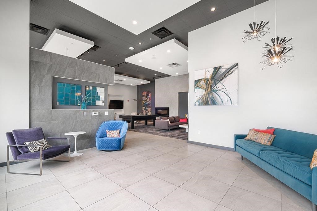 a living room with a blue couch and chairs
