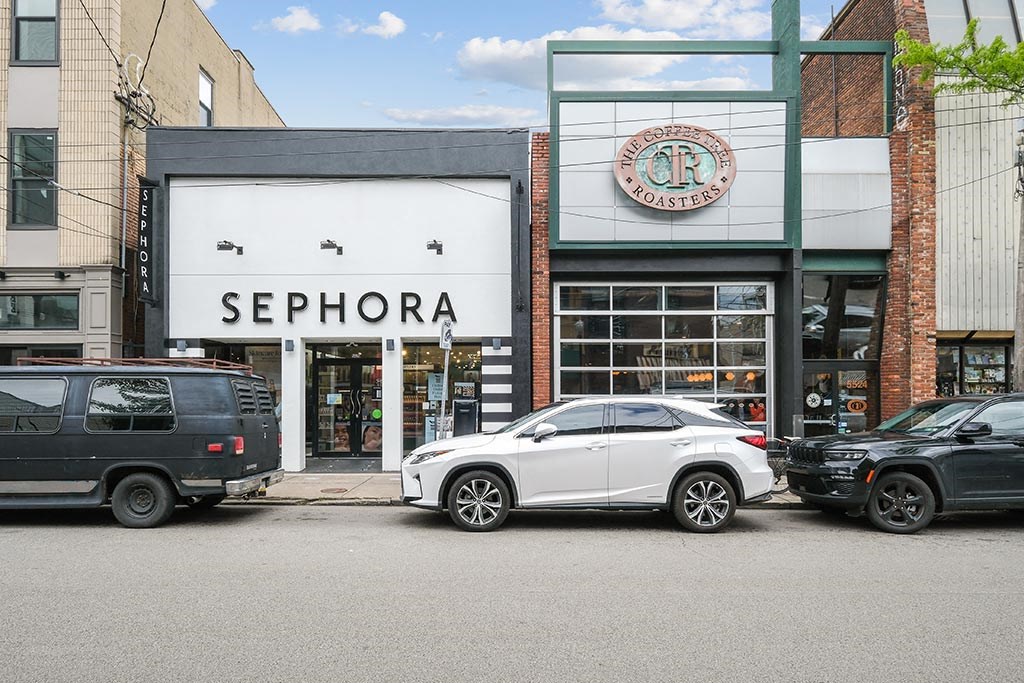 a sephora store with cars parked in front of it