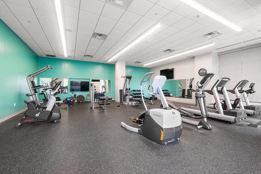 a gym with various exercise equipment and weights
