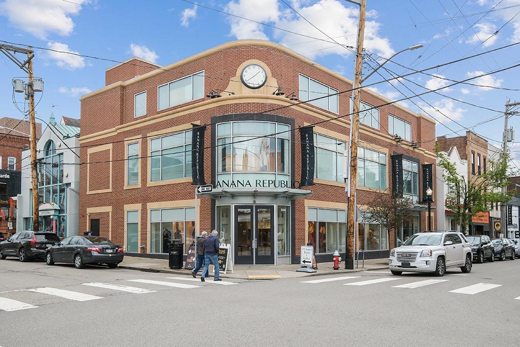 a building with a clock on the front of it on a city street