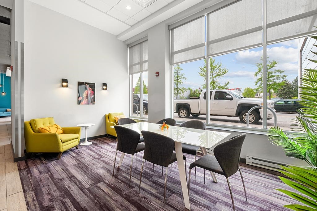 a dining room with a table and chairs and a large window