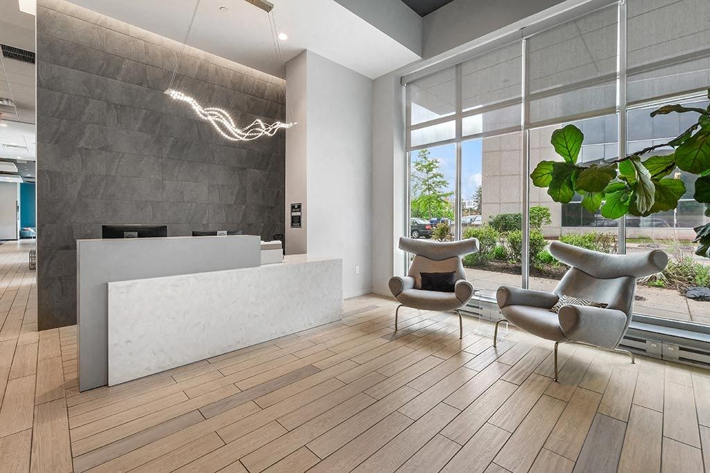 a lobby with a reception desk and chairs