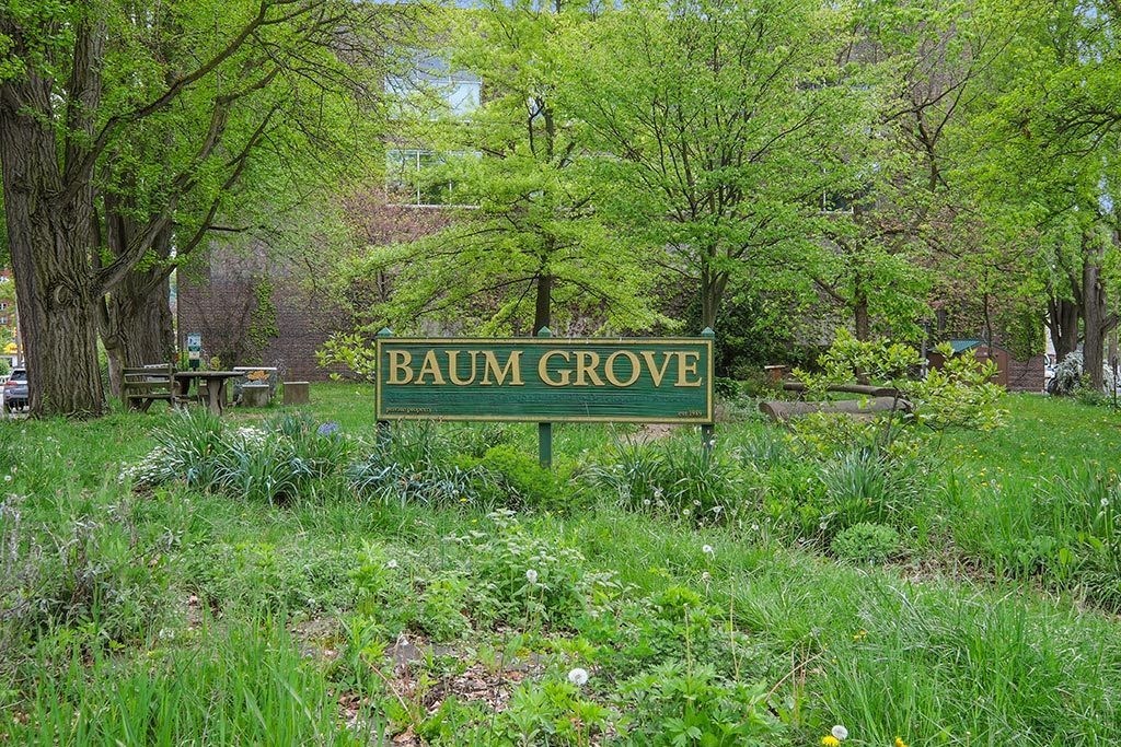 a green sign in the middle of a field