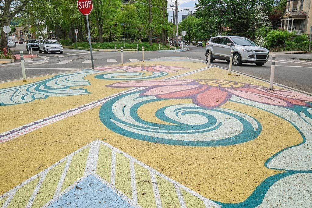 a multicolored crosswalk with a design on a street