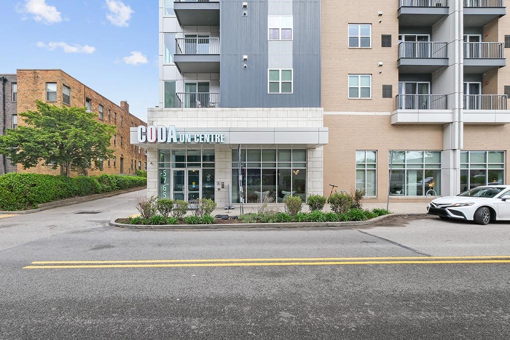 an apartment building with a car parked in front of it