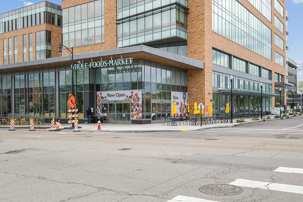 a building on the corner of a street with traffic cones