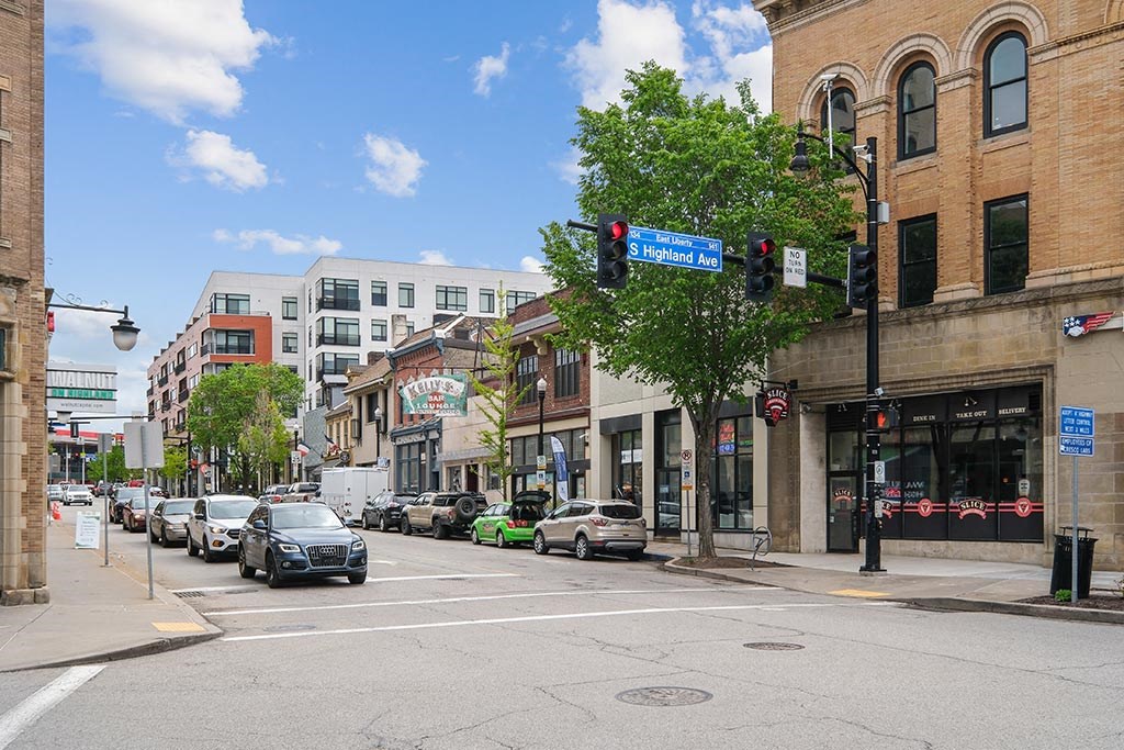 a city street with cars stopped at a traffic light