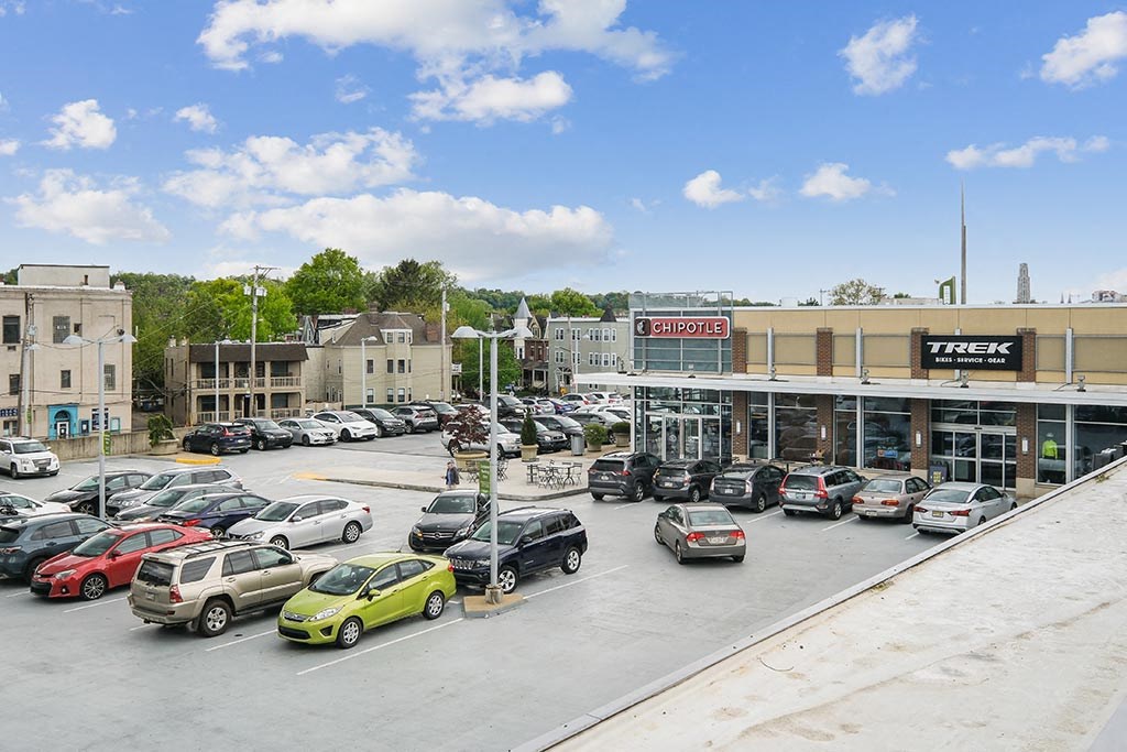 a parking lot filled with cars in front of a building