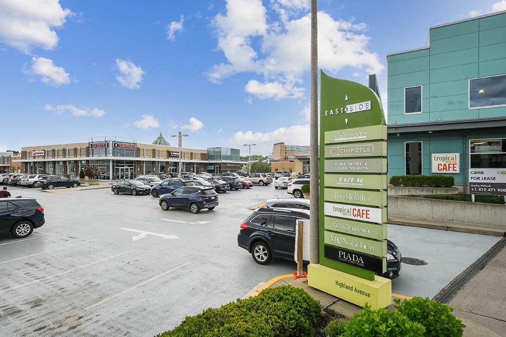 a parking lot with cars parked in front of a gas station