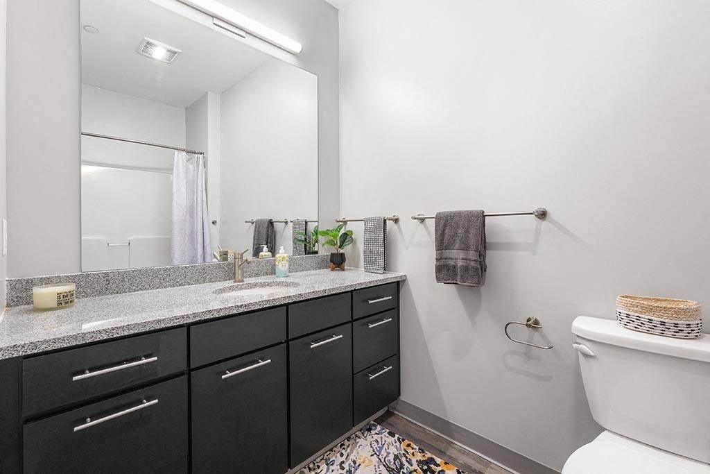 a bathroom with a toilet sink and a mirror