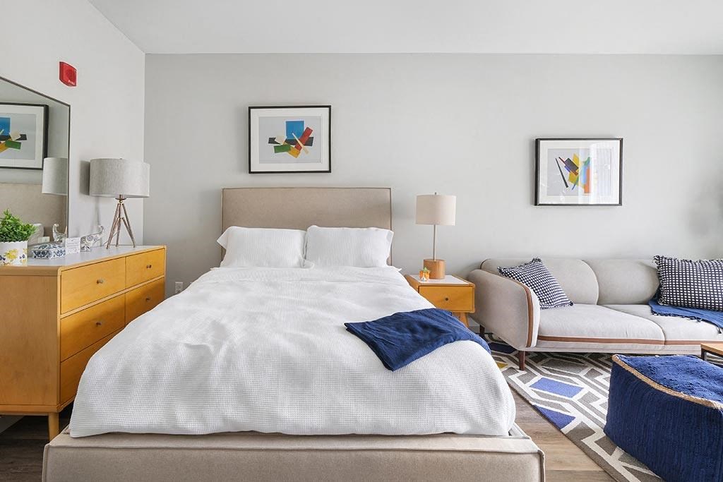 a bedroom with a bed and a couch