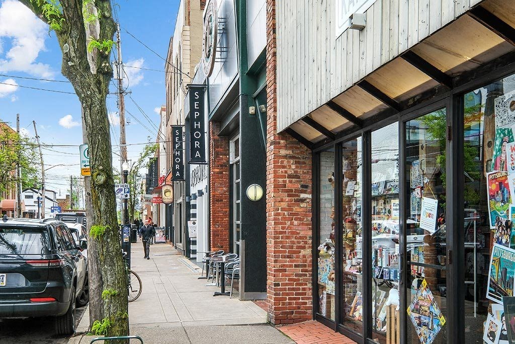 a city street with a person walking down the sidewalk