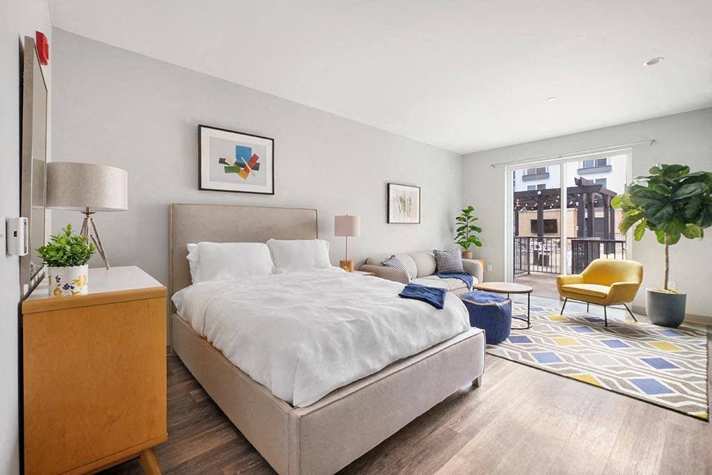 a bedroom with a bed and a living room