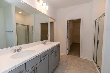 a bathroom with two sinks and a large mirror