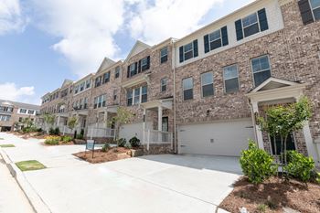 an apartment building with a garage door in front of it