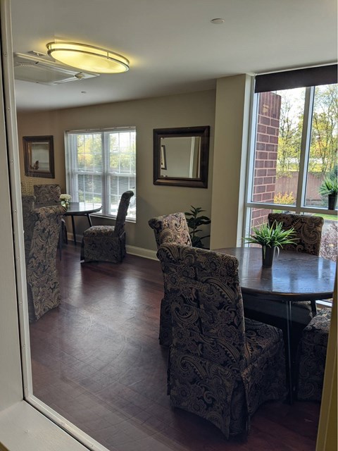 A dining room with a table and chairs.