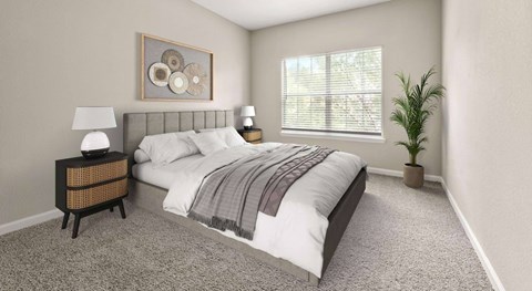 A bedroom with a large bed, a nightstand with a lamp, a framed picture on the wall, and a potted plant.