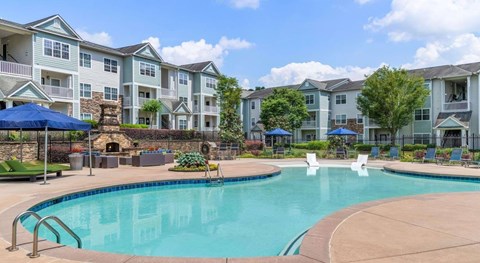 A swimming pool in front of apartment buildings.