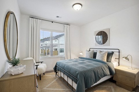 Secondary bedroom with queen size bed and large window letting in a ton of natural light.