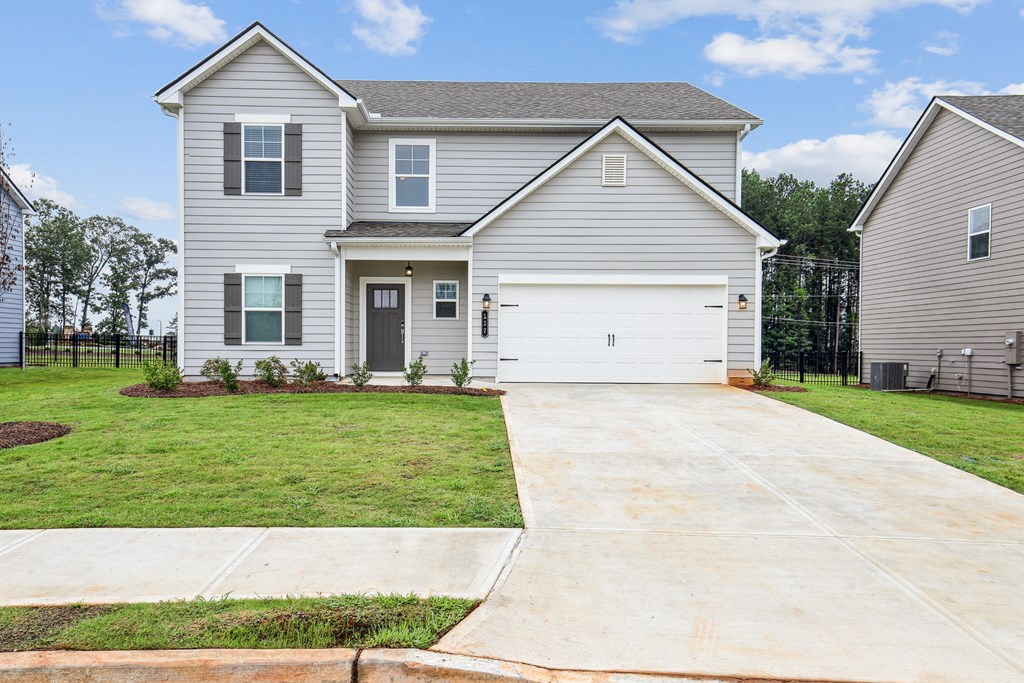 Exterior of the Hastings, two story home with a private driveway and attached garage.