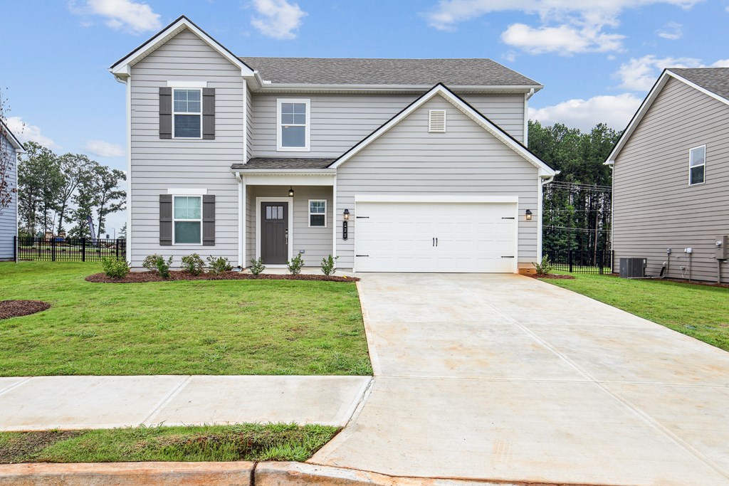 Exterior of the Hastings, two story home with a private driveway and attached garage.