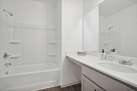 Secondary bathroom with tub shower and single vanity.