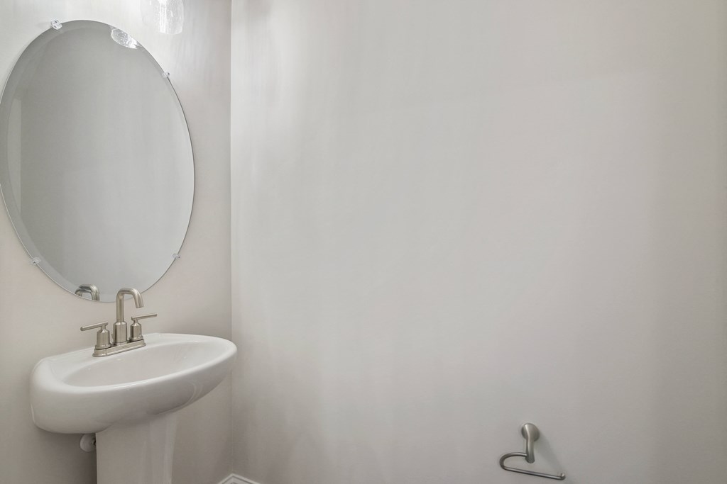 a bathroom with a sink and a mirror and a toilet