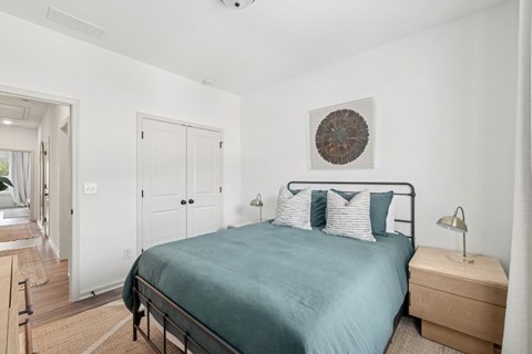 Secondary bedroom with queen size bed and large window letting in a ton of natural light.