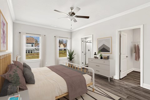 A bedroom with a bed, dresser, and mirror.