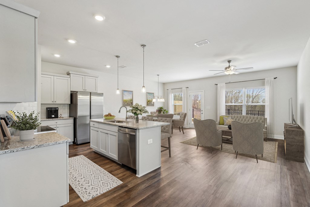 the gathering room and kitchen of a new home with an open floor plan