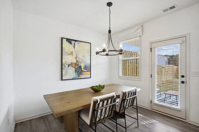 the dining room of a home with a wooden table and chairs