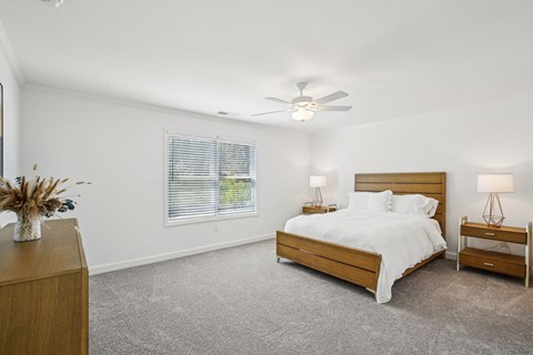 Primary Bedroom with king size bed and large window letting in nice natural light.
