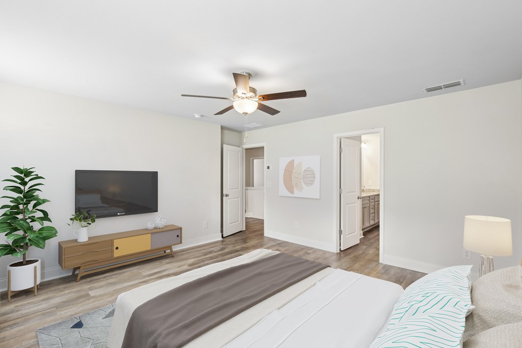 “Serene primary suite with a plush king bed, refined finishes, and calming greenery—your private retreat for rest and relaxation.”