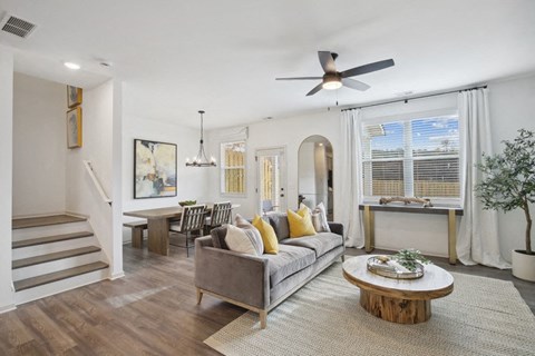 Spacious living area with easy access to the stairwell and upper levels.