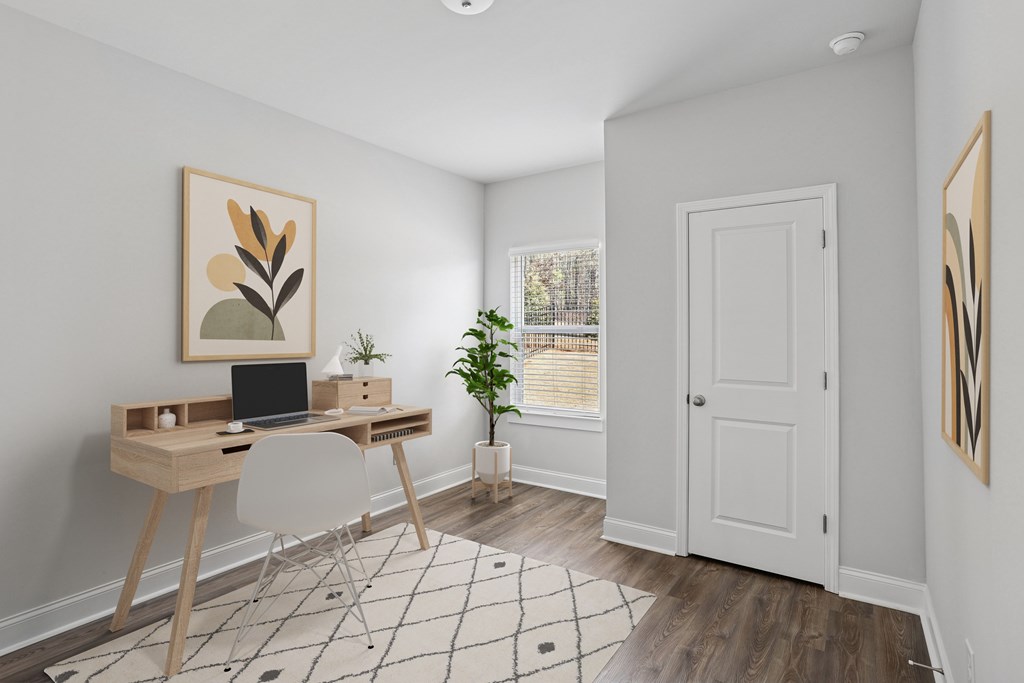 Primary bedroom with space for a desk and chair.