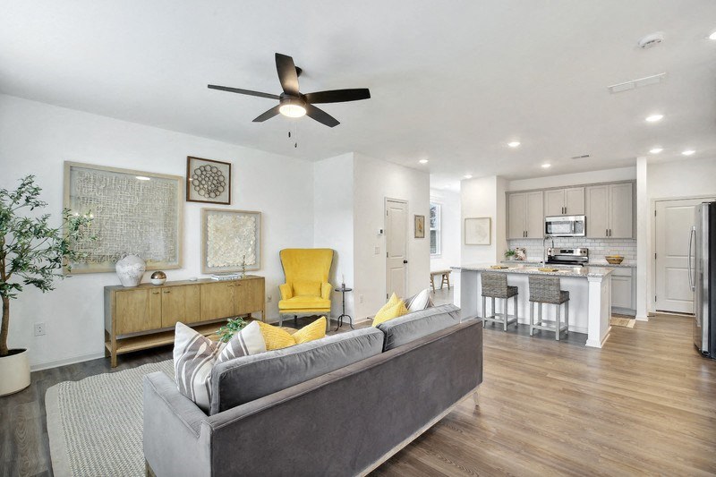 a living room with a couch and a ceiling fan