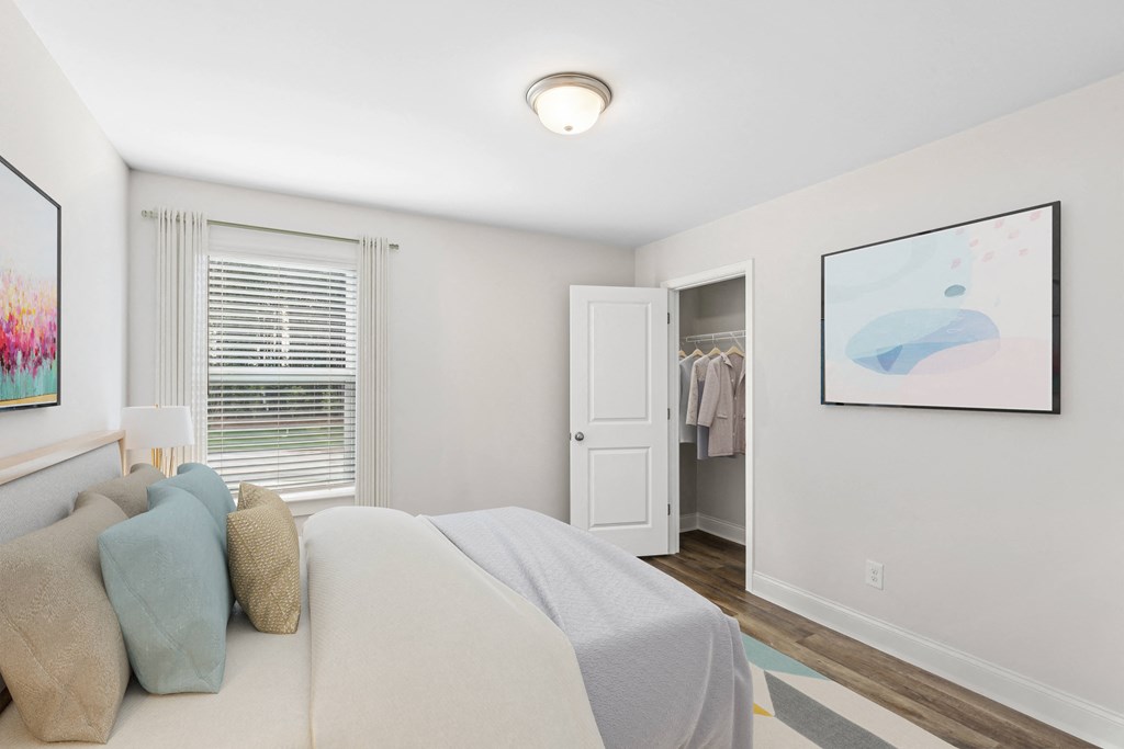 Secondary bedroom with queen size bed and large window letting in a ton of natural light.