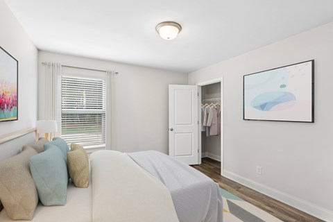 Secondary bedroom with queen size bed and large window letting in a ton of natural light.
