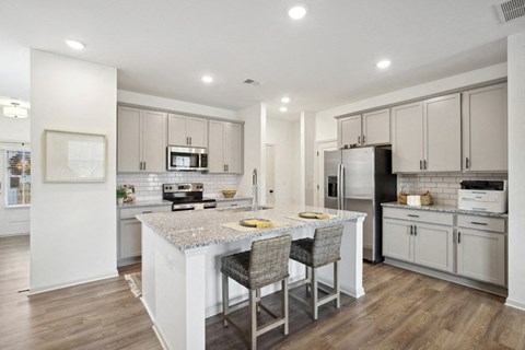 Kitchen island with bar seating. looking into the full kitchen.