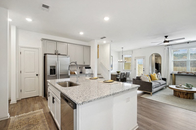 a kitchen with an island and a living room with a couch