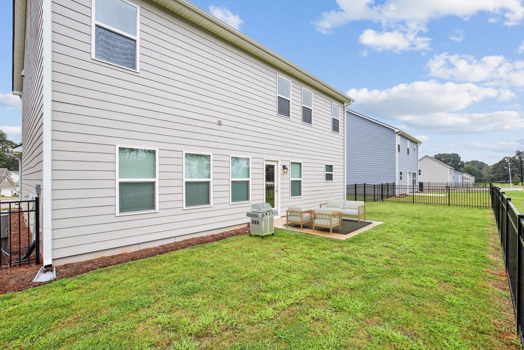 Back patio with fenced in yard.