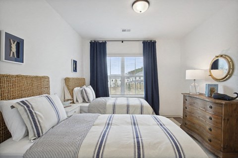 Relaxing shared bedroom with twin beds and a nautical-themed nightstand detail.