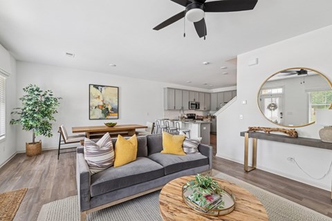 Living room with open view to kitchen and stairwell.