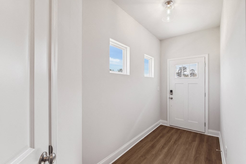a bedroom with white walls and a white door