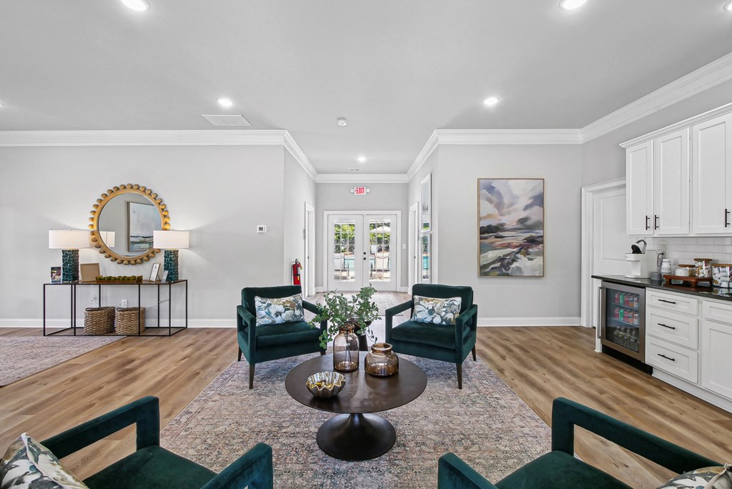 Spacious clubhouse lounge with ample seating and a convenient kitchenette.