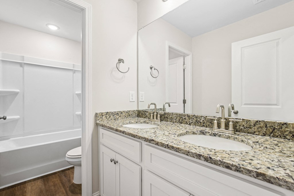 Secondary suite bathroom with a tub and shower combination