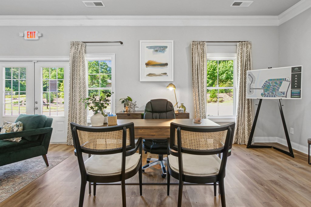 Clubhouse interior with leasing desk and relaxing sitting area.